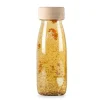 Botella sensorial flotante transparente y dorado Float Bottle - Petit Boum