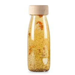 Botella sensorial flotante transparente y dorado Float Bottle - Petit Boum